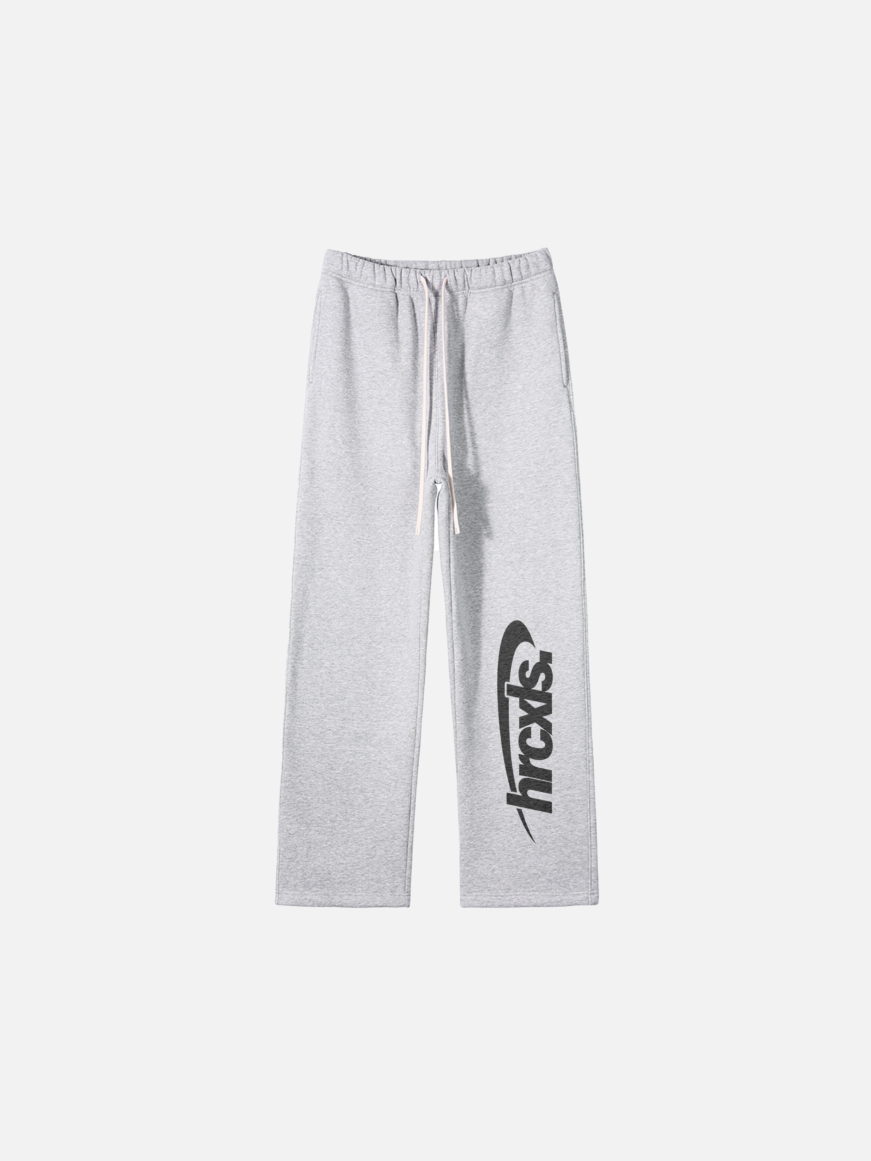 Athletic light grey sweatpants flat lay with large dark logo on right leg