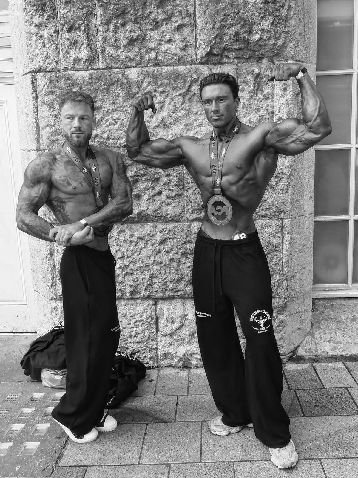 Worldwide Competitor Sweatpants - Black / White model standing in joggers with medal (p4)