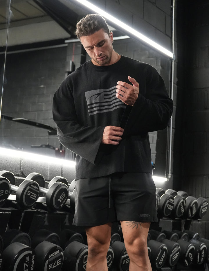 Athlete wearing a black HERCXLES bodybuilding rag long sleeve in the gym