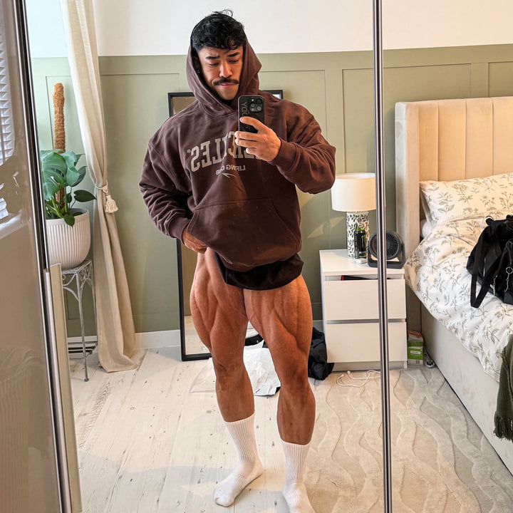 Athlete taking a mirror selfie in a chocolate HERCXLES heavyweight hoodie