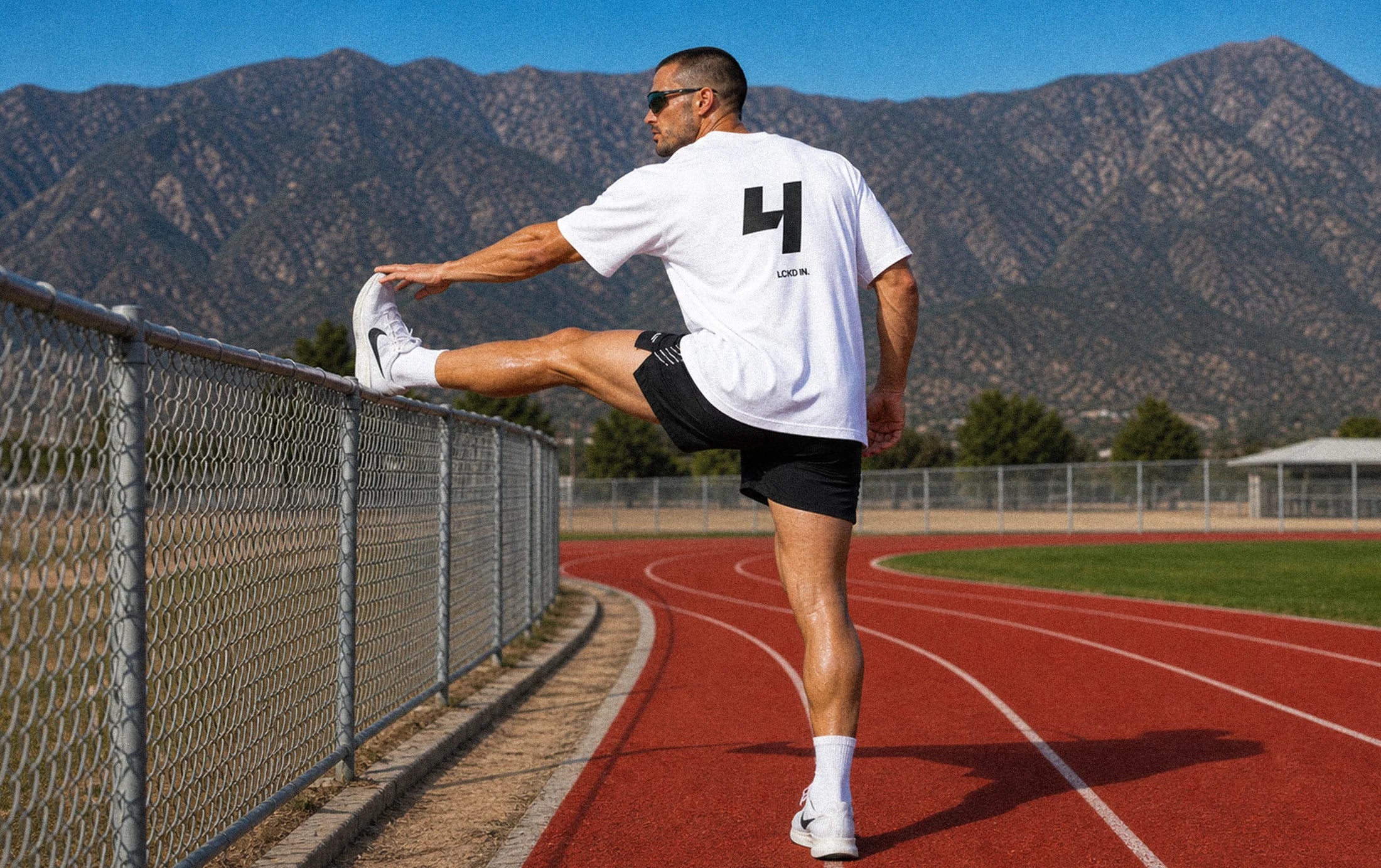 LCKD IN training apparel on an outdoor track